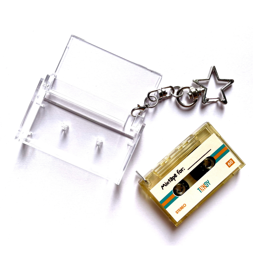 Mini Cassette NFC keychain with a star charm on a white background