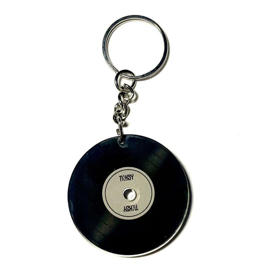 Vinyl NFC keychain shaped like a mini record, perfect for music lovers to play tracks with just a tap of their NFC-enabled device.