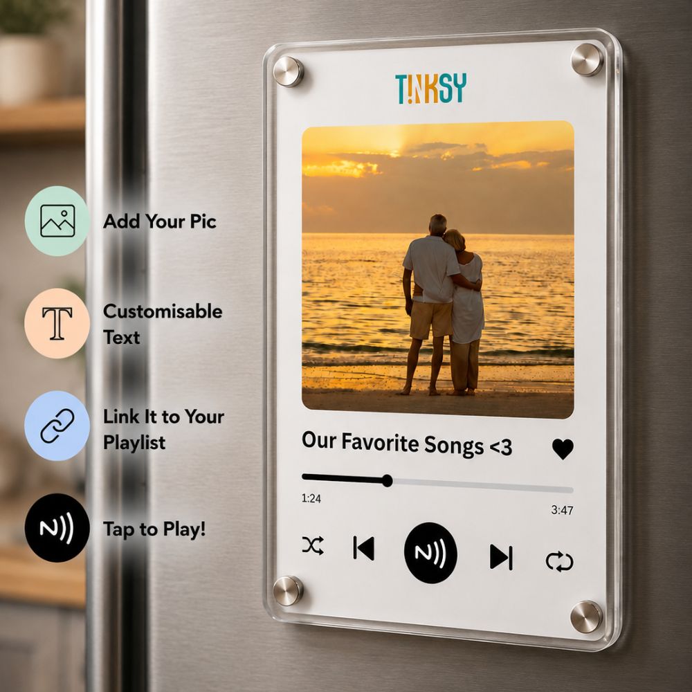 A clear acrylic music fridge magnet on a stainless steel refrigerator.