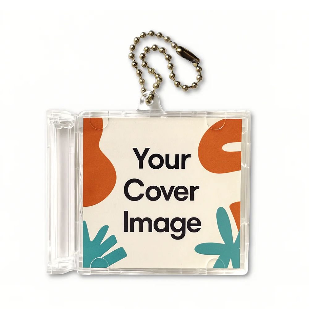 A Mini CD NFC keychain which is clear, plastic keychain holder displays a colorful card with the text Your Cover Image, featuring abstract shapes in orange and teal. The keychain is attached to a small metal ball chain for easy attachment to bags or keys.